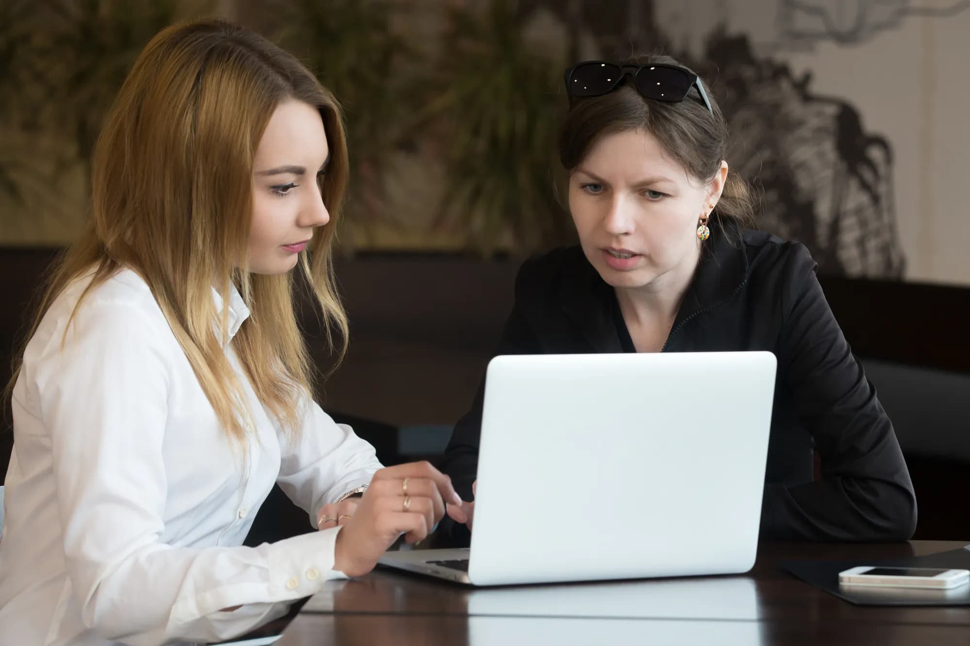 Team reviewing work on a laptop